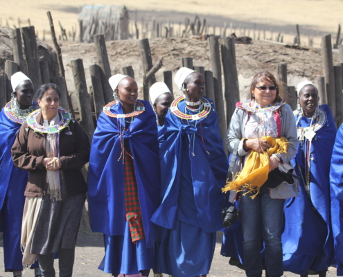 a group of Maasai women with guests in the Ngorongoro Conservation area