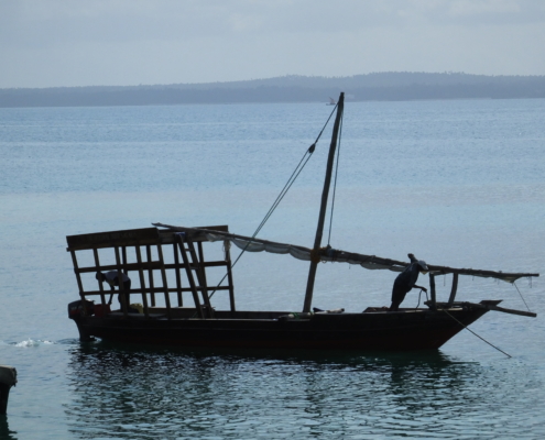 small wooden fishing boat on the ocean near Zanzibar